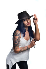 Dark long haired girl wearing a cowboy hat and a sleeveless white shirt posing isolated on white.