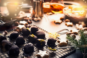 Homemade festive confectionery , pralines and truffles on dark rustic background with ingredients....