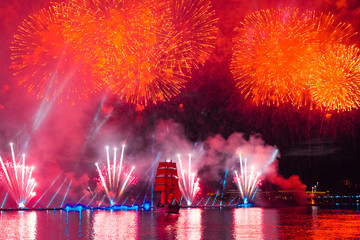 SAINT-PETERSBURG, RUSSIA - JUNE 23, 2018: Swedish brig Tre Krunur on  the annual celebration school graduates "Scarlet Sails" in St. Petersburg. Festive fireworks and light show over the Neva river.