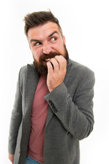 Man bearded hipster doubtful face bites finger while thinking. Nervous make decision. Hipster...