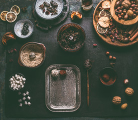 Healthy vegan homemade truffles making preparation on dark background with ingredients: dates, dried cranberries, prunes,nuts, almond paste, ground almonds, cocoa powder and marshmallows, top view