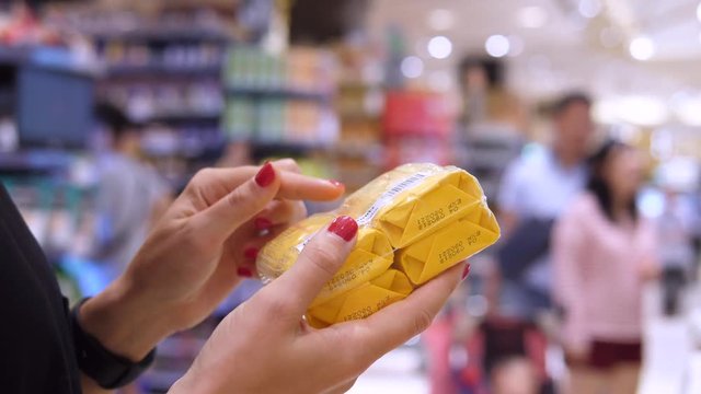 Female Hands Holding Soap While Shopping At Supermarket And Checking Ingredients On Label