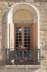 classic Spanish restored building facade with window and flower planter box