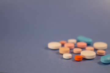 Pills of colors in a neutral background. Medications in the form of tablets.