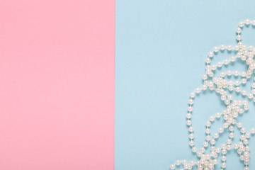 pearl necklace on a blue and pink background