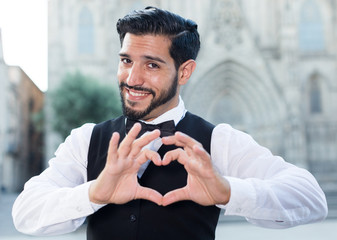 Man gesturing heart with his fingers