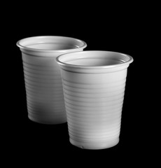 white plastic cups isolated on black background, clipping path