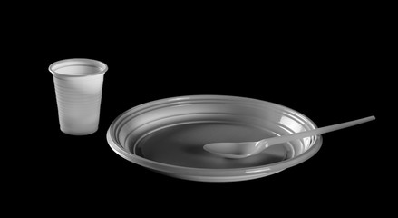 Disposable white plastic plate with spoon and fork clipping path, isolated on black background