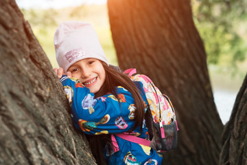 Smiling kid girl in park after school