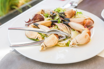 Boiled crab claws on a plate in seafood restaurant
