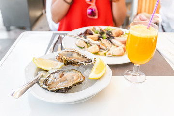 Oysters on the plate at the restaurant with lemon