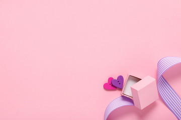 gift box and two hearts on pink background