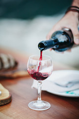 Close Up of Hand Pouring Wine