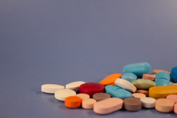 Pills of colors in a neutral background. Medications in the form of tablets.