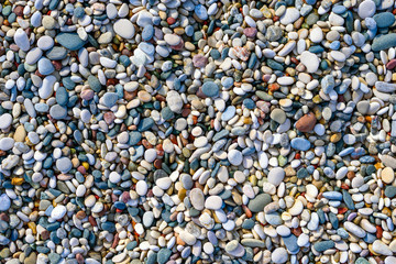 Texture of colorful sea stones on the beach, top view, Flatley