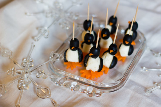 Naklejki Healthy fun art food snacks as appetizers or for children in the shape of penguins with carrots, mozzarella cheese and olives