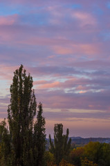 Landscape with dramatic light - beautiful golden sunset with saturated sky and clouds.