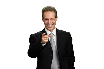 Happy businessman indicating with finger to camera. Portrait of joyful business executive pointing his finger towards camera, isolated on white background.