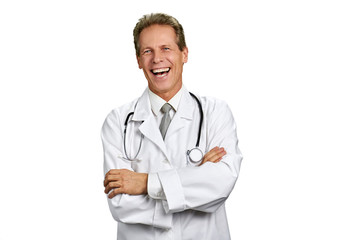 Fototapeta premium Portrait of laughing doctor on white background. Cheerful male doctor crossed arms isolated on white background, copy space. Positive medical specialist.