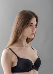 Fototapeta premium Standard model tests of young pretty woman on a gray background,Test Shots young models for modeling agency on a gray background with ,young beautiful woman in underwear. portrait of slim woman 