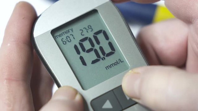 Patient with diabetes using blood glucose meter. Viewing blood glucose results