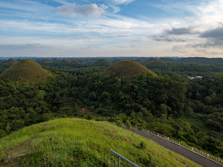 Fototapeta na wymiar Chocolate hills, geological formation in the Bohol island, Philippines. They are covered in green grass that turns brown (like chocolate) during the dry season. November, 2018