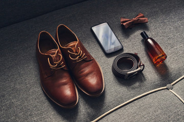 different accessories of a businessman for creating a style of a people lie on a wooden background