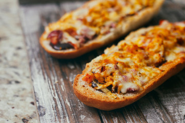 French baguette sandwich with assorted filling. Dish on wooden table. Set of bruschetta.
