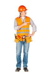 Portrait of a male builder in a helmet  looking at camera over white wall background. repair, construction, building, people and maintenance concept.