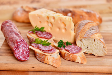 Sandwich with sausage and cheese. Breakfast on the table.