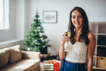 Christmas. Portrait of young woman in the living room at home. New Year, morning, leisure, winter.