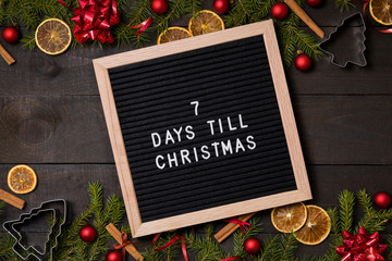 seven Days till  Christmas one week  countdown letter board on dark rustic wood background with...