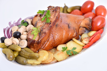 German kitchen. Pork leg. Meat dish with vegetables.