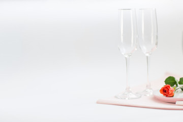 Dinner on Valentine's day. couple glasses and a rose on the table. copy space
