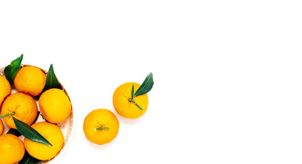 Pile of mandarins in white bowl on white wooden background