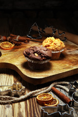 Chocolate muffin and nut muffin, homemade bakery wooden background