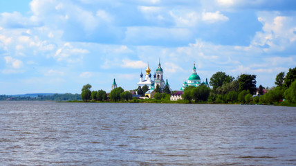 Far orthodox church on the lake shore
