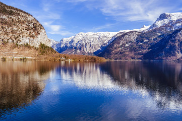 Fototapeta na wymiar Big calm lake with snow covered mountain on the background