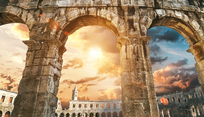 Pula amphitheatre arches with sunset sky background