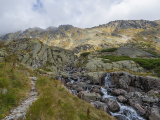 Valley Mlynska Dolina in slovakia mountains with Panoramic view on Strbske pleso village and mountain river stream, High Tatra Mountains, Slovakia, summer