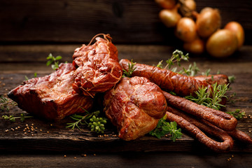Smoked meats and sausages. A set of traditional smoked meats and sausages: ham,gammon, pork loin, home-style sausages, kabanosy. Traditional meats and sausages smoked in apple, beech and juniper wood 