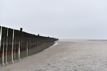 Fototapeta na wymiar piles at a silent beach