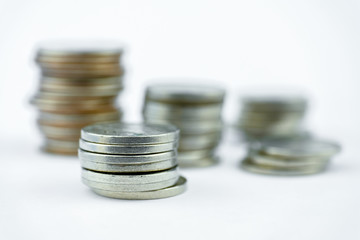 Stacks of coins on a white background. Close up.