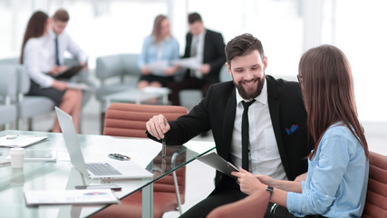business couple discussing working paper sitting at Desk