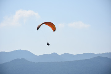 Paraglider on a clear day for background usage. Spaces for type.