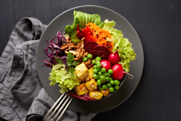 Fresh salad, Buddha bowl,  healthy and nutritious salad with a variety of vegetables, nuts and tofu...