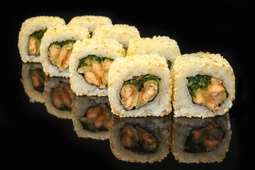 Traditional sushi roll with salmon on black stone. Japanese food