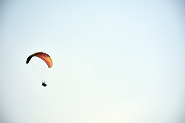 Paraglider on a clear day for background usage. Spaces for type.