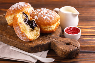 Tasty sweet sugary chocolate donuts with raspberry jam and milk - obrazy, fototapety, plakaty