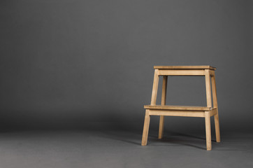 Wooden chair isolated on gray background in the studio.
